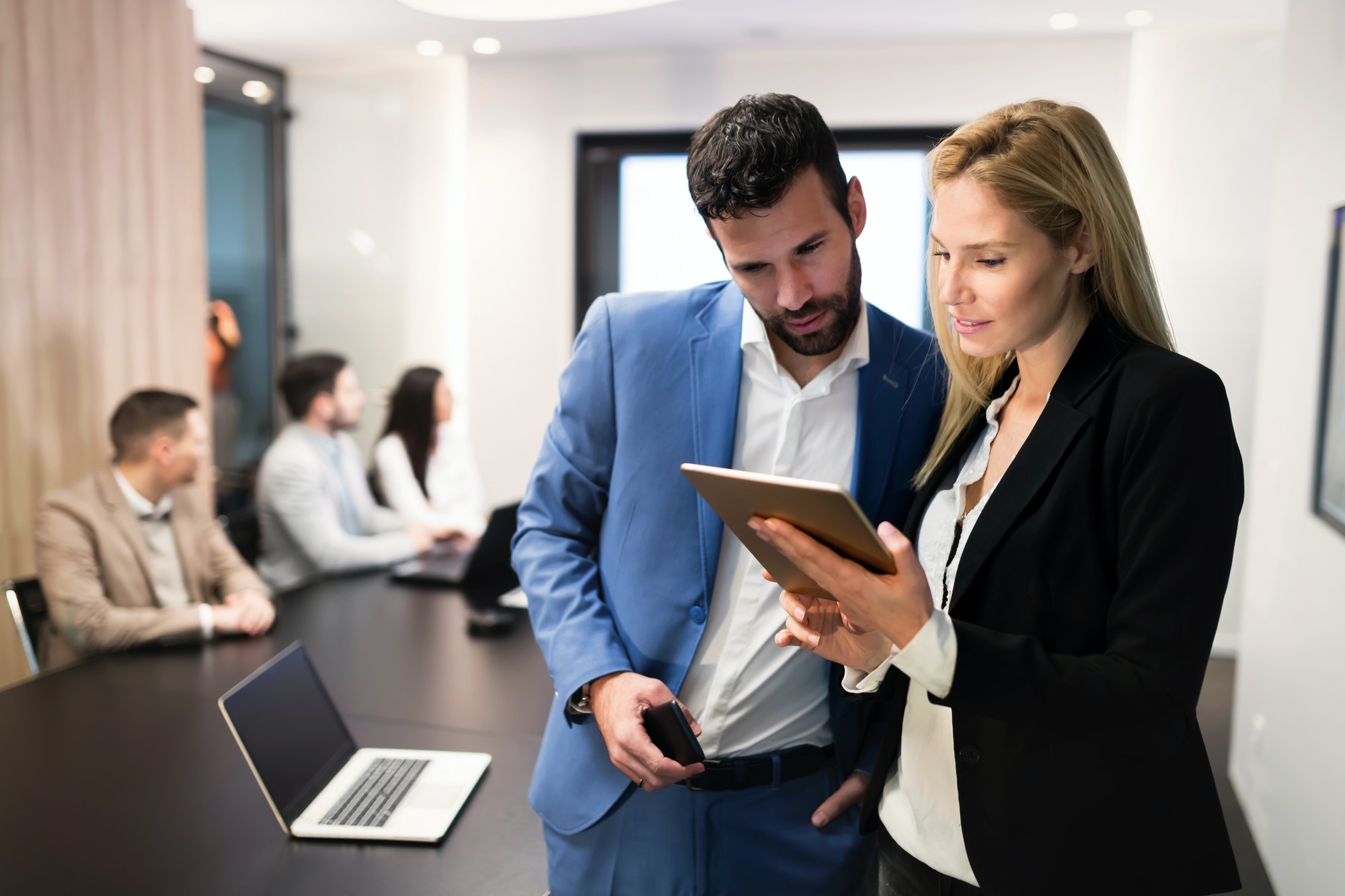 attractive-business-couple-using-tablet-in-their-company.jpg
