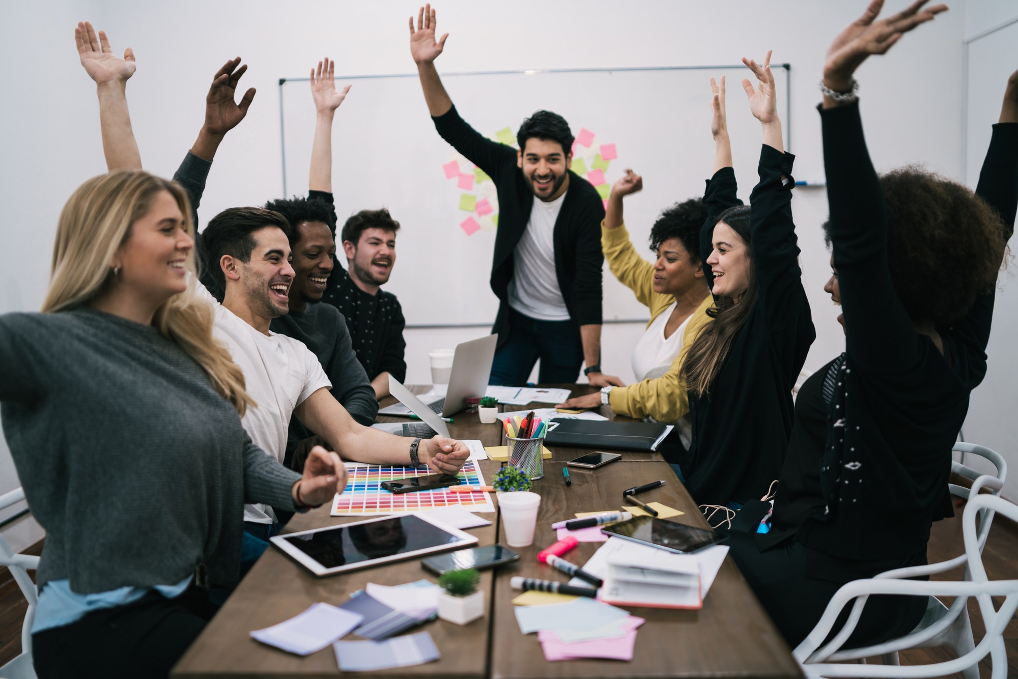 business-team-celebrating-with-raised-up-hands-.jpg