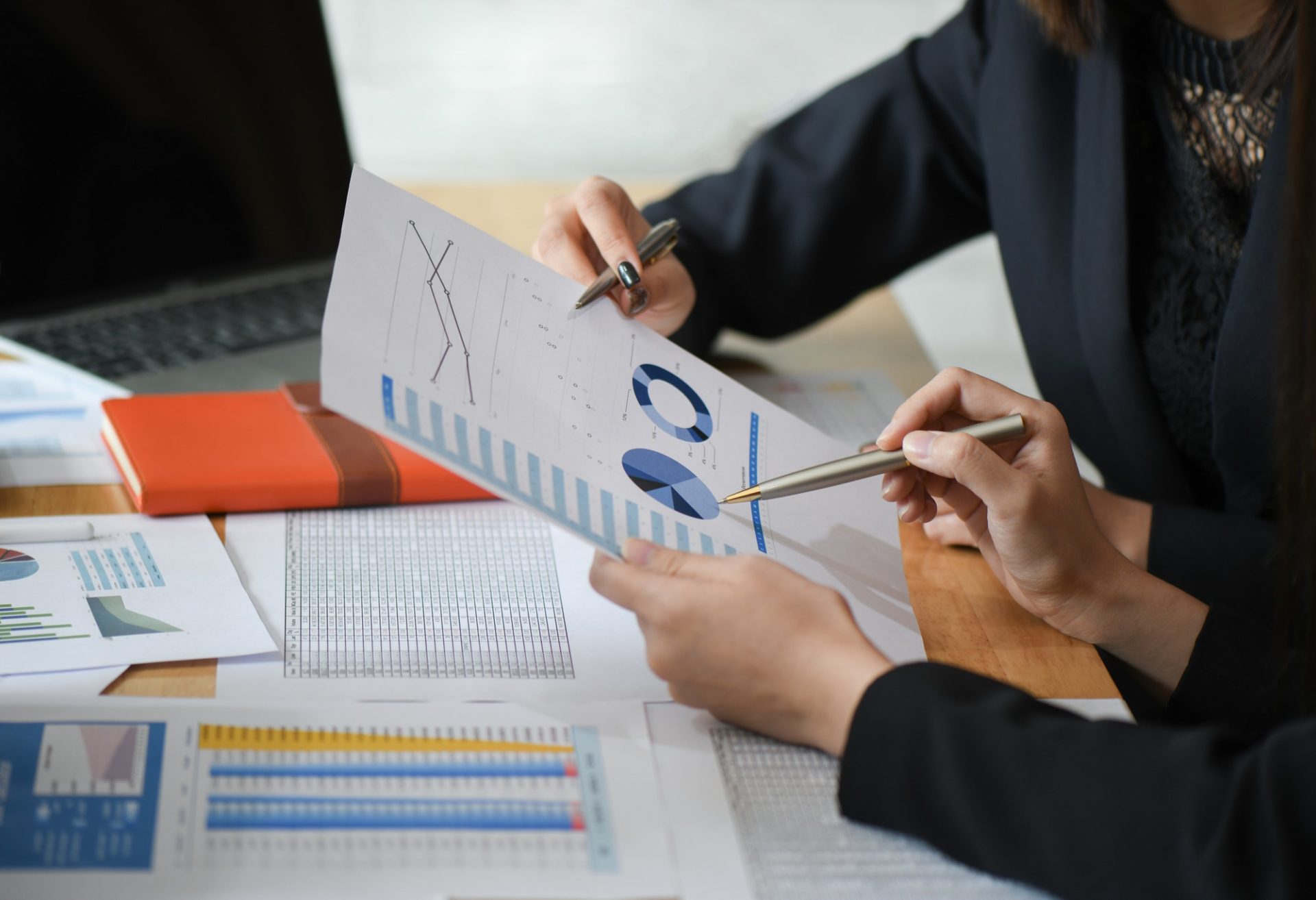 female-accountant-team-is-analyzing-data-documents-in-the-office-e1603246057633.jpg